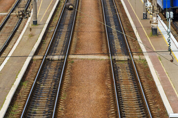 Fototapeta na wymiar view of the infrastructure of the railway station - rails, platform and passenger railcars, without people