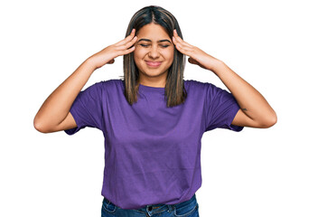Obraz na płótnie Canvas Young hispanic girl wearing casual purple t shirt with hand on head for pain in head because stress. suffering migraine.