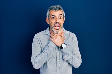 Handsome middle age man with grey hair wearing business shirt shouting and suffocate because painful strangle. health problem. asphyxiate and suicide concept.