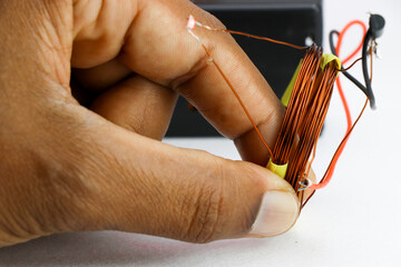 Wireless electricity transfer experimental setup is shown using insulated copper wires and SMD led...