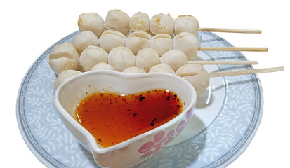 Close up grilled pork meatballs with sauce on the plate on white background