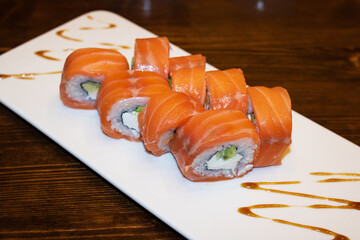 Philadelphia rolls on a white plate closeup