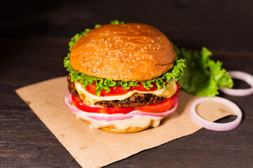 Close-up of delicious homemade burgers on a wooden table on a dark background beef hamburger Freshly cooked delicious - top view