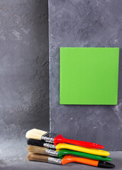 Paintbrushconstruction tool on cement wall background