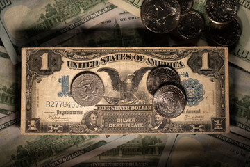 Half Dollar coin on antique one Dollar banknote