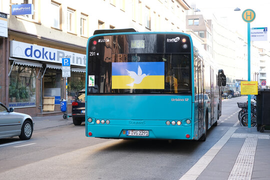 Frankfurt - March 2022: green urban shuttle bus at the bus stop with pacifist banners, an anti-war rally near Consulate General of Russian Federation, concept Germany is no war