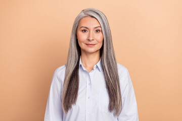 Fototapeta premium Photo of mature adorable lady intelligent attorney marketer chief isolated over beige color background