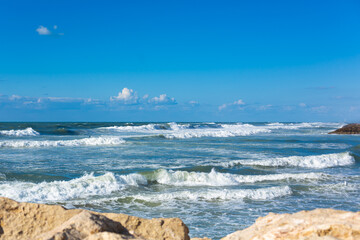 Fototapeta na wymiar Seashore in Tel Aviv. Waves in the sea