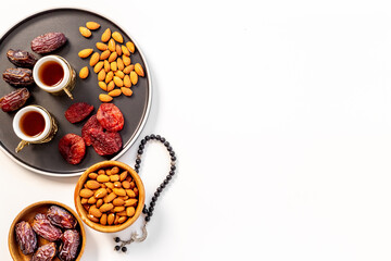 Ramadan Kareem concept. Islamic rosary with star and crescent and dates fruits