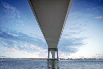 Under a large bridge over the sea