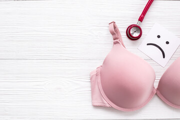Women health and breast cancer concept with pink bra and stethoscope