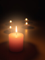 Light a candle in the dark, the flame warms and the light creates bokeh. Light and shadow create atmosphere. Things such as romantic, mysterious, interesting, and also make you feel faith.