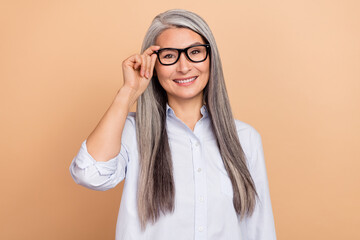 Photo of senior woman eyewear boss intelligent formalwear representative isolated over beige color background