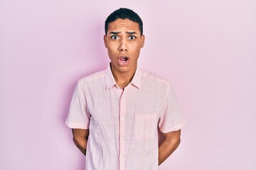 Young african american guy wearing casual clothes scared and amazed with open mouth for surprise, disbelief face