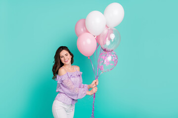 Portrait of gorgeous friendly person hold balloons toothy smile isolated on turquoise color background