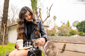 Animal lover young businesswoman caresses to cat. Loving animals with positive feelings.