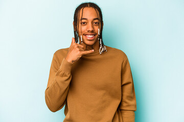 Young African American man isolated on blue background showing a mobile phone call gesture with fingers.