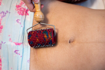 Postpartum doula shows how to massage a cesarean scar with a Lyapko applicator. Recovery procedures...