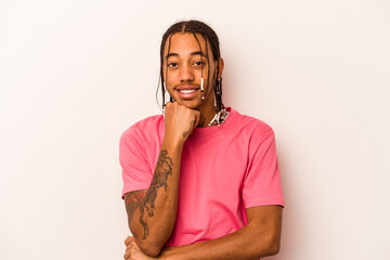 Young African American man isolated on white background smiling happy and confident, touching chin...