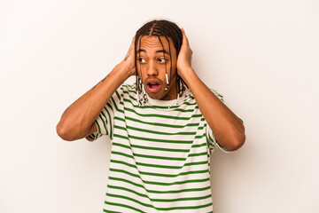 Young African American man isolated on white background screaming, very excited, passionate,...