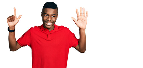 Young african american man wearing casual red t shirt showing and pointing up with fingers number...