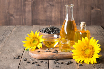Sunflower oil with seeds on traditional rustic wooden background. 