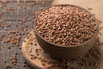 Buckwheat groats on wooden background. Healthy cereal concept.  