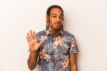 Young African American man isolated on white background rejecting someone showing a gesture of disgust.