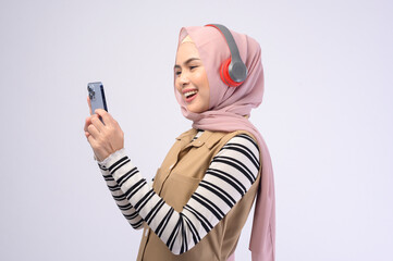 Young beautifu musliml woman wearing headset on white background