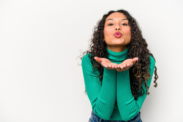 Young hispanic woman isolated on white background folding lips and holding palms to send air kiss.