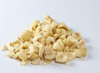 Heap of chopped or diced hazelnut isolated on white background