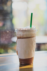 Iced coffee on wooden table in cafe house