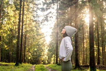 Profile of a sporty woman breathing deeply fresh air in a forest after exercise and keeping fit...