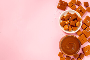 Bowl of caramel sauce and toffee candies with sea salt, top view