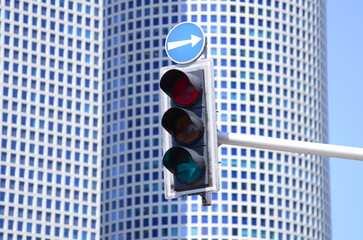 Traffic lights over urban intersection. city crossing with a semaphore, red and orange light in...