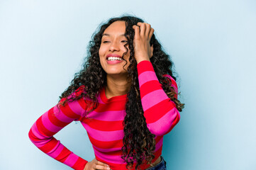 Young hispanic woman isolated on blue background joyful laughing a lot. Happiness concept.