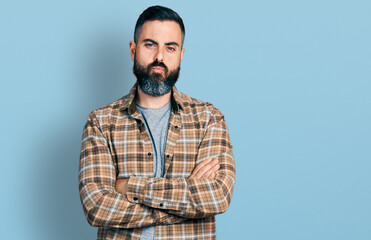 Hispanic man with beard with arms crossed gesture looking at the camera blowing a kiss being lovely and sexy. love expression.