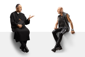 Punk and a priest sitting on a white panel and talking isolated on white background