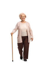 Smiling elderly woman walking towards camera with a cane