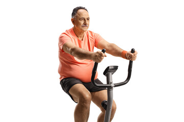 Mature man exercising on a stationary bike