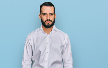 Obraz premium Young man with beard wearing business shirt depressed and worry for distress, crying angry and afraid. sad expression.