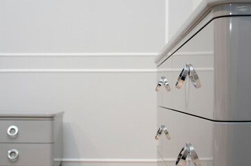 Modern round knobs on a polished cabinet. Modern furniture, furniture design. Minimalistic style in the interior.