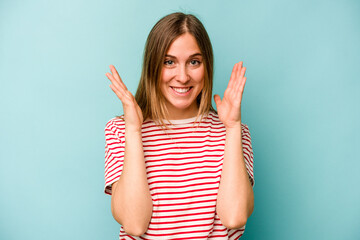 Young caucasian woman isolated on blue background laughs out loudly keeping hand on chest.