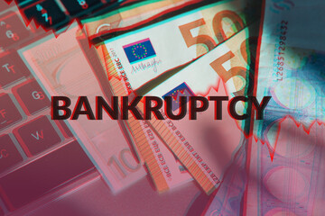 Concept of economic crisis. The word bankruptcy on the euro currency background.