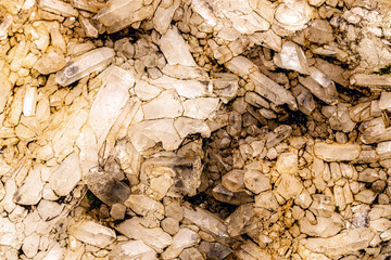 quartz mine, detail of raw crystals on the wall of a mine, concept of precise stone being mined