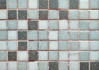 Grey ceramic mosaic stone tiles on cement background texture