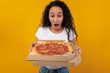 Shocked Woman Holding Box With Pizza At Studio