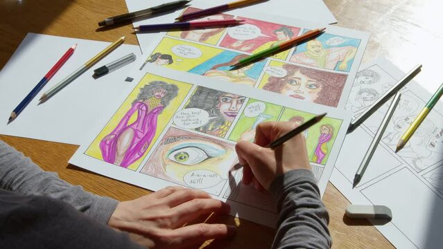 The artist draws comic book characters on paper. Illustrated drawings of a colorful storyboard.