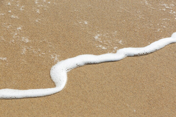 Fototapeta na wymiar sea ​​foam on the beach
