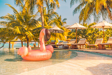 Summer tourism swimming pool inflatable pink flamingo, luxury resort hotel poolside. Happy sunset tropical paradise island infinity pool sea view. Vacation, holiday fun landscape. Relax leisure